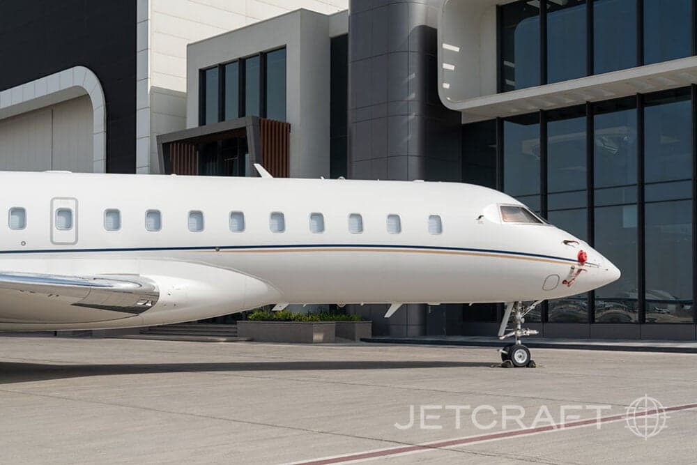 Close up of a white Bombardier Global Express business jet on the tarmac.