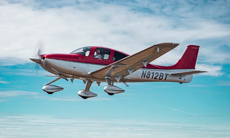 Cirrus SR22 aircraft N812BT in flight with a red and silver paint scheme.
